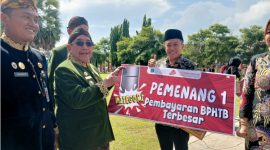 Bupati Sumenep menyerahkan piagam penghargaan kepada Dr. Naghfir, S.HI., S.H., M.Kn., CPM., CH., C.Ht. atas kontribusinya sebagai Notaris/PPAT dengan pembayaran BPHTB terbesar dalam mendukung peningkatan PAD Kabupaten Sumenep